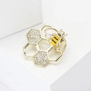 Broche abeille et nid d'abeille dorée avec zircons brillants pour vêtements de femme
