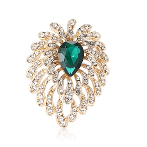 Elegant gold firework brooch with teardrop green gemstone and sparkling rhinestones