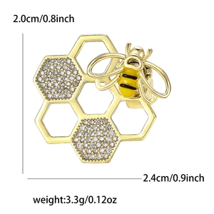 Broche abeille et nid d'abeille dorée avec cristaux brillants et détails en émail