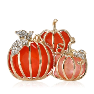 Elegant gold pumpkin brooch with orange crystals and sparkling rhinestones on white base