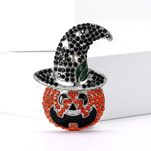 Macro shot of Halloween pumpkin wizard brooch with sparkling orange and black rhinestones