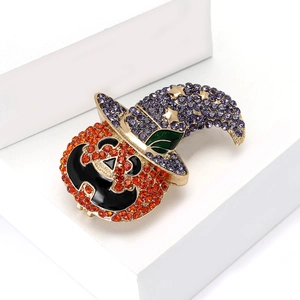 Exquisite Halloween pumpkin wizard brooch with orange and purple rhinestones on white stand