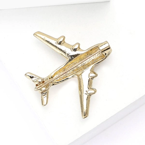 Detail view of the golden airplane brooch back with a secure pin clasp mechanism