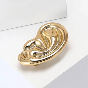 Modern gold alloy ear-shaped brooch with a polished mirror finish for suits