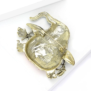 Detailed back view of antique gold pumpkin brooch showing the secure pin fastening mechanism
