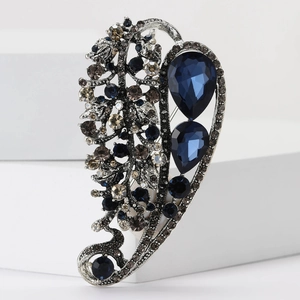 Vintage silver alloy leaf brooch with deep blue teardrop rhinestones and hollow design