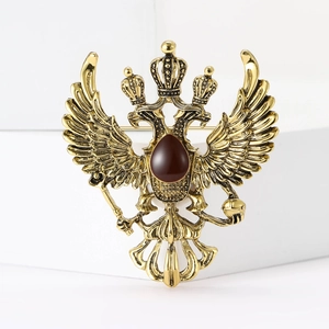 Vintage gold double-headed eagle brooch with red resin gem and Russian crest design