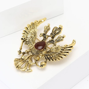 Vintage antique gold Russian double-headed eagle brooch with a dark red teardrop gemstone