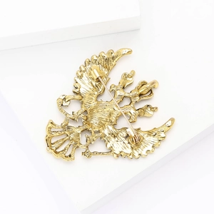 Detailed back view of golden eagle brooch showing pin fastener and metal texture