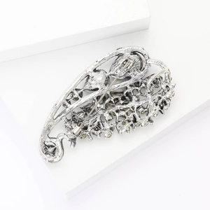 Detailed back view of vintage hollow leaf brooch showing secure pin and rhinestone setting