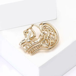Polished gold skeleton head brooch in minimalist hollow design for clothing