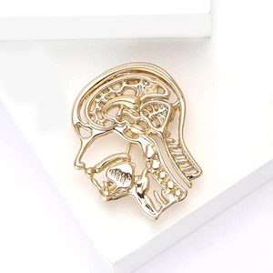 Minimalist gold alloy brooch featuring an anatomical side-cut head and neck design