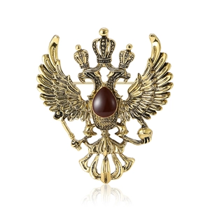 Vintage gold Russian double-headed eagle brooch with red stone and matte finish