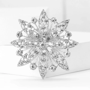 Macro shot of silver-tone hollow snowflake brooch with sparkling crystal rhinestones