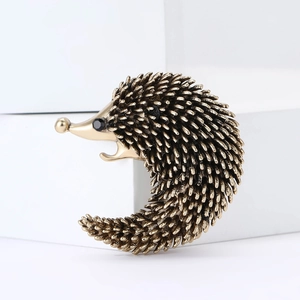 Fashionable hedgehog brooch pin with vintage gold finish and black crystal eyes