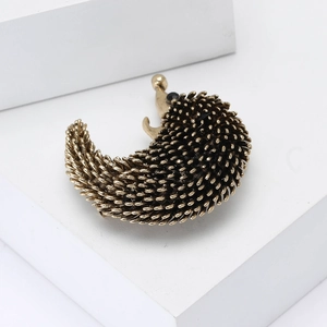 Vintage gold alloy hedgehog brooch with enamel detail and black bead eye for sweaters