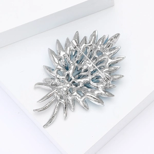 Detailed back view of silver alloy crystal brooch showing safety pin clasp and hollow metalwork