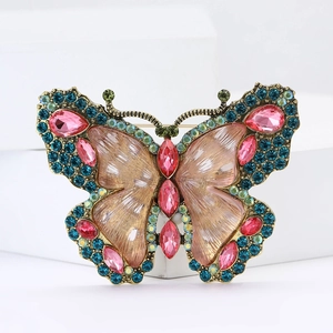 Elegant butterfly brooch with blue and pink rhinestones on a vintage gold metal base