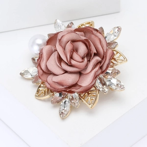 Elegant fabric flower brooch with rhinestones and pearl on white geometric background