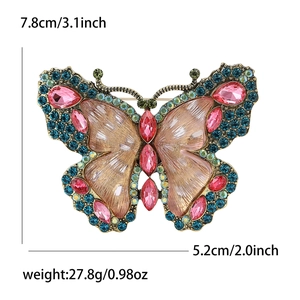 Luxurious rhinestone butterfly brooch in vintage gold with pink and blue crystals
