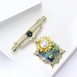 Vintage sunflower stamp brooch with blue gemstone and pearls in gold finish