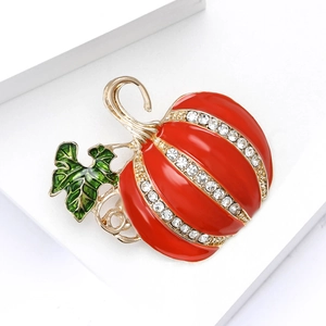 Halloween pumpkin brooch in red enamel with gold stem and sparkling rhinestones