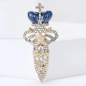 Macro detail of gothic skull crown brooch with colorful rhinestones and blue enamel sword