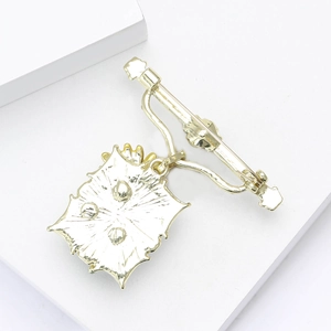 Detail view of gold vintage sunflower brooch back showing secure pin and alloy texture