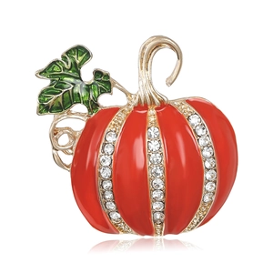 Elegant red enamel pumpkin brooch with crystal rhinestones on a white reflective base