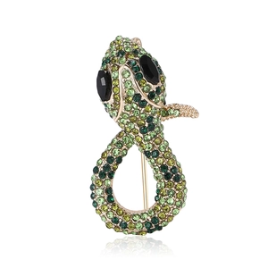 Sparkling snake brooch with green rhinestones and black gem eyes in gold finish