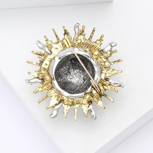 Detailed back view of vintage sunburst brooch showing steady pin buckle and metal texture
