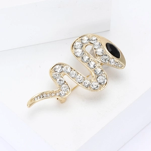 Elegant gold snake brooch with sparkling rhinestones and black gem eye on stone base