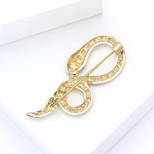 Macro view of gold-plated alloy brooch back showing the secure safety pin clasp structure