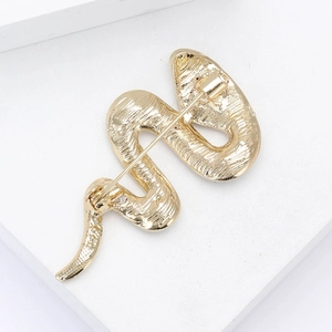 Detailed back view of gold snake brooch showing scale texture and safety pin clasp
