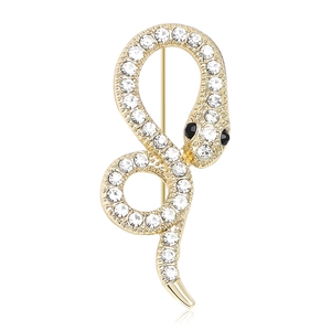 Sparkling gold snake brooch with white rhinestones and black gem eyes on white background