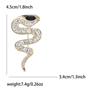 Golden snake brooch with white crystals and black eye, dimensions 4.5cm by 3.4cm