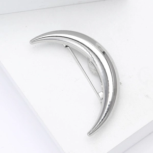 Detailed back view of a polished silver crescent moon brooch with secure pin clasp