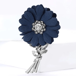 Elegant navy blue fabric flower brooch with rhinestones and silver leaves on white base