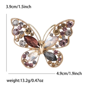 Elegante spilla a farfalla dorata con strass colorati e cristalli taglio marquise