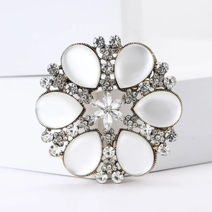 Vintage floral brooch with cat eye stones and sparkling crystals on antique gold alloy