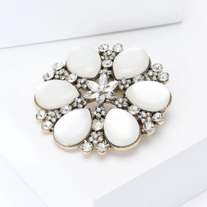 Exquisite gold snowflake brooch with teardrop cat eye stones and sparkling crystals