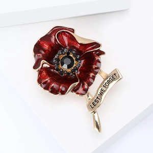 Red poppy brooch with Lest We Forget engraving and black crystals on gold base