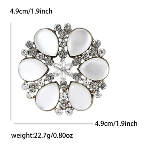 Elegant gold-tone snowflake brooch with cat-eye stones and rhinestones, size 1.9 inch