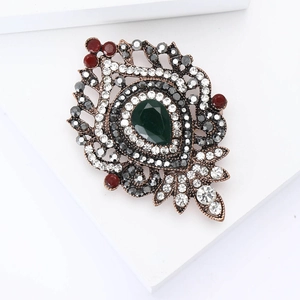 Vintage bronze alloy brooch with green teardrop crystal and colorful rhinestones