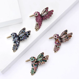 Exquisite set of four hummingbird brooches featuring vibrant enamel and colorful crystals