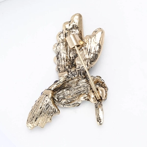 Detailed back view of a gold hummingbird brooch showing secure metal safety pin clasp