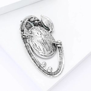 Macro view of vintage silver alloy brooch back with secure pin and safety lock details