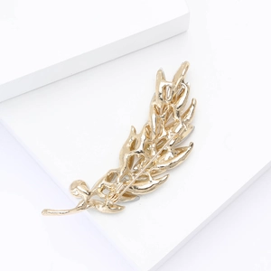 Detailed back view of gold feather brooch showing secure safety pin clasp and plating