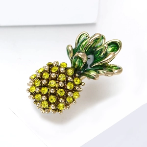 Sparkling pineapple brooch with yellow rhinestones and green enamel on a golden base
