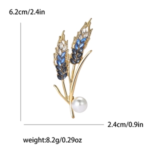 Classic gold wheat brooch with blue crystals and a large white pearl for elegant suits